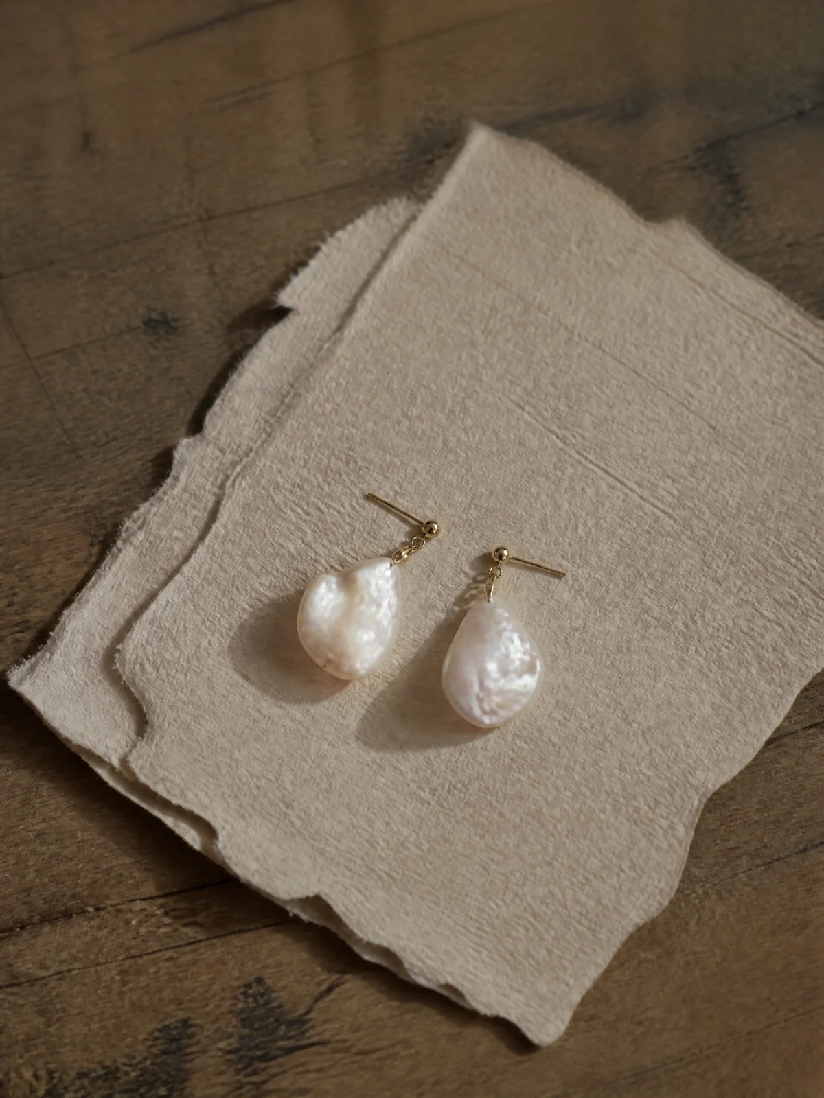 Generated pearl earrings on textured fabric